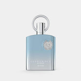 The "Supremacy in Heaven EDP Perfume for Men 3.4 oz/100 ml" by Afnan is presented in a blue, rectangular bottle adorned with a circular silver cap and an intricate crest-designed silver emblem near the top. The gradient transitions from darker to lighter blue, creating a tranquil atmosphere that perfectly complements its exquisite fragrance notes.