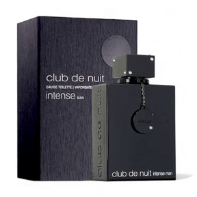 A black rectangular bottle of Armaf's Club de Nuit Intense Man EDT Perfume for Men 3.6 oz/105 ml, a woody spicy fragrance, stands next to a matching black box labeled with the same text. The bottle features a round black charm hanging from its neck and a square black cap, embodying contemporary masculinity.